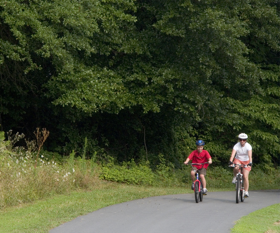 baker-12 Shown here is an eight-year-old boy riding bikes with his mother. The trail is part of the Rails to Trails network.